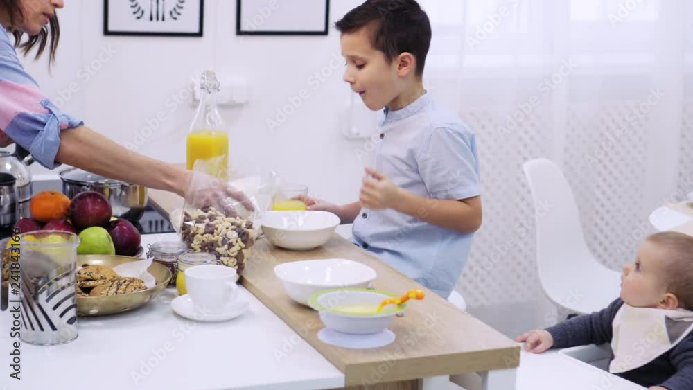 Mother with kids having breakfast Mother with kids having breakfast