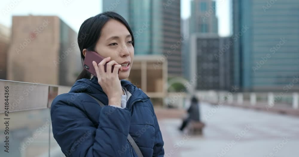 Woman talk to cellphone in the city Woman talk to cellphone in the city
