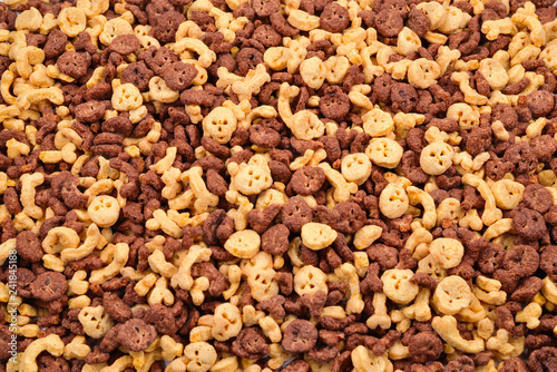 Chocolate flakes in the form of skulls and bones background. Top view.