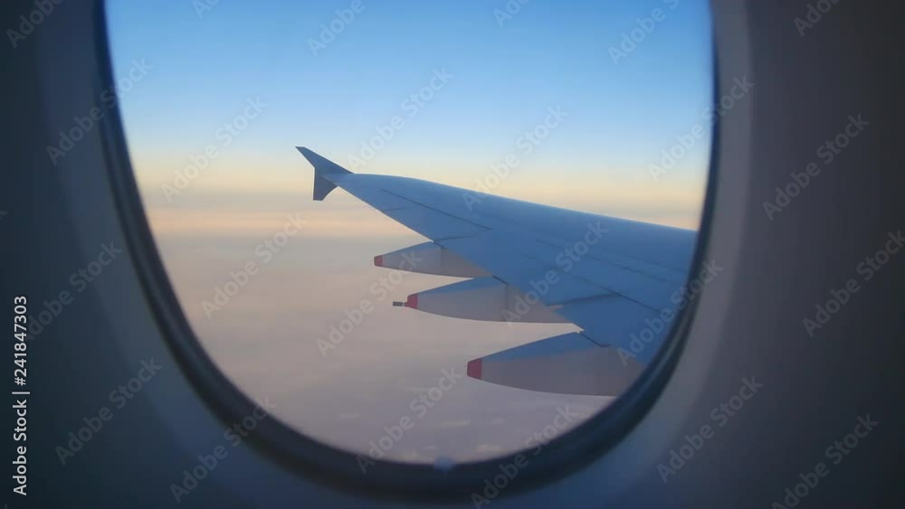 Travel Video View from the Airplane window seat. Twilight view in the early morning reduces speed and landing. Reduce the level of flight to destination with clouds and colorful sky background. Travel Video View from the Airplane window seat. Twilight view in the early morning reduces speed and landing. Reduce the level of flight to destination with clouds and colorful sky background.