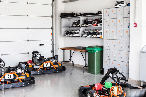 garage for karting storage, shelves with helmets and storage boxes. Summer, active family fun or sports