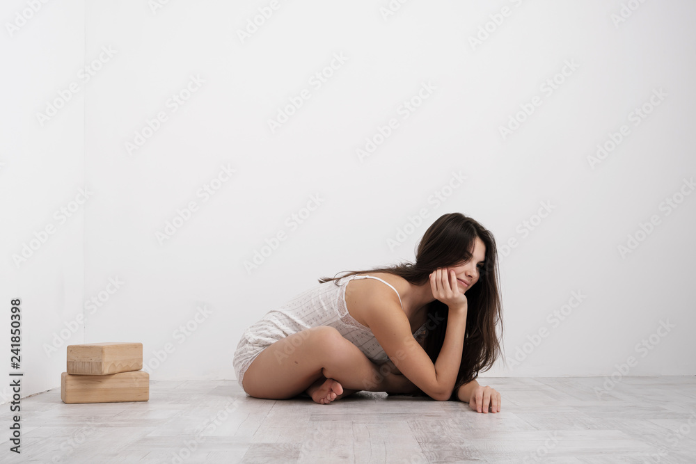 Woman in home clothes doing exercises on the floor. Balances on the blocks. Woman in home clothes doing exercises on the floor. Balances on the blocks.