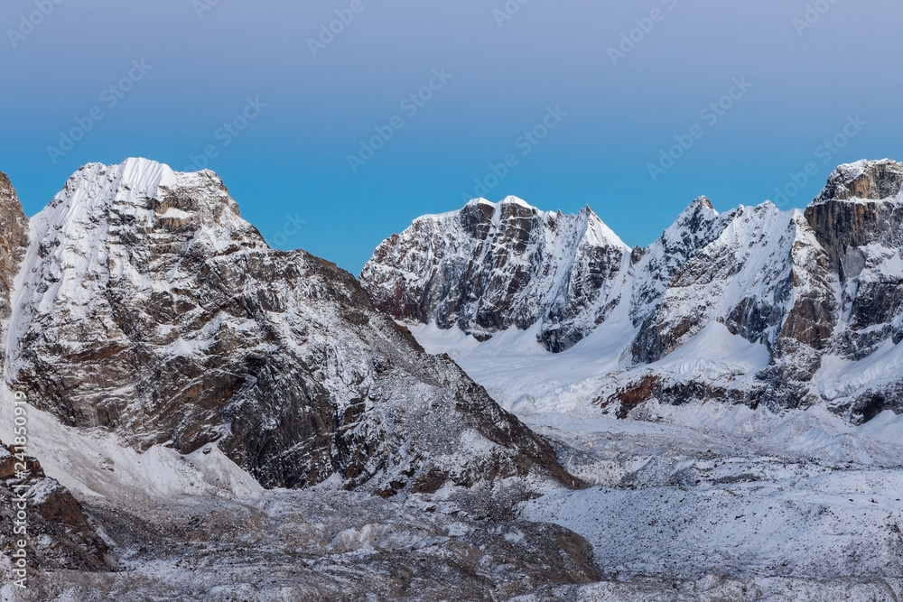 Beautiful snow and ice covered mountains landscape and clear blue morning sky on Everest Base Camp Trek in Himalayas, Nepal. Adorable photo.
