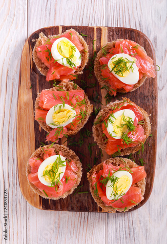 Snacks with salmon, quill egg and dill