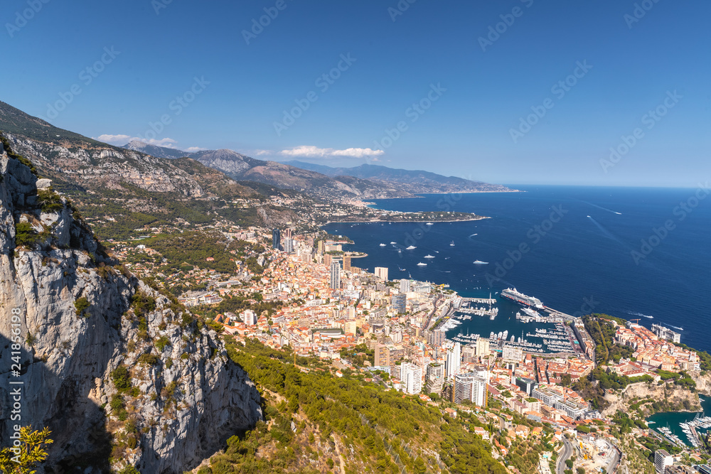 Aerial view of Kingdom of Monaco, view from La Turbie, landmark of Monaco, Monte-Carlo, port Hercules, port Fontvieille, Monaco Ville, Palace of Prince, orange color of roofs, Cruise liner, blue sea