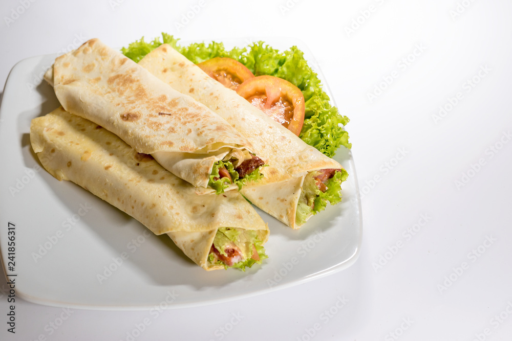 Fresh tortilla wraps with vegetable filling and chicken - white background