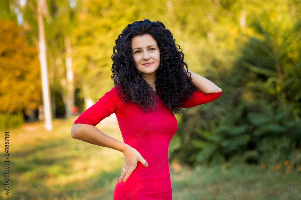 Happy beautiful young woman in red dress relax in summer park. Freedom and harmony concept Happy beautiful young woman in red dress relax in summer park. Freedom and harmony concept