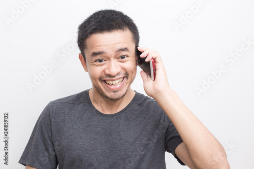 Smiling mustache asian man use smart phone felling surprise on white background