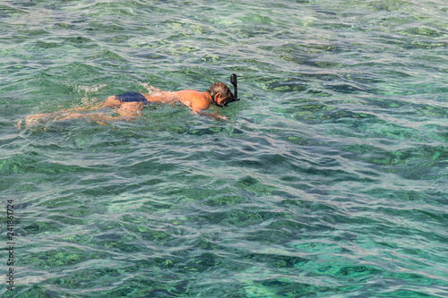 man with snorkel mask tuba and snorkel in sea. Snorkeling  swimming  vacation. Tourists are engaged in snorkeling in the open sea. Holidays in the seaside resort.