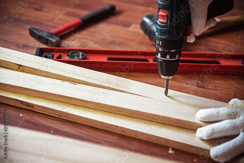 machine. Professional carpenter working with wood and building tools