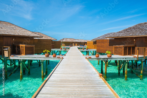 Wooden walkway to resort in Maldive. © happystock