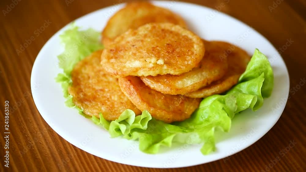potato pancakes with lettuce leaves in a plate potato pancakes with lettuce leaves in a plate