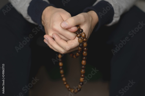 Prayer beads for meditation in men's hands. Peace, awareness and mindfulness