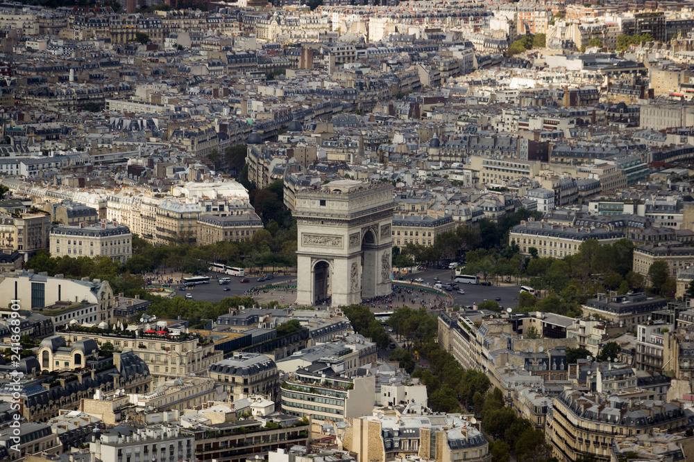 Paris City view with Arc De Triomphe in the center surrounded by Buildings, Busy Streets and Tourists