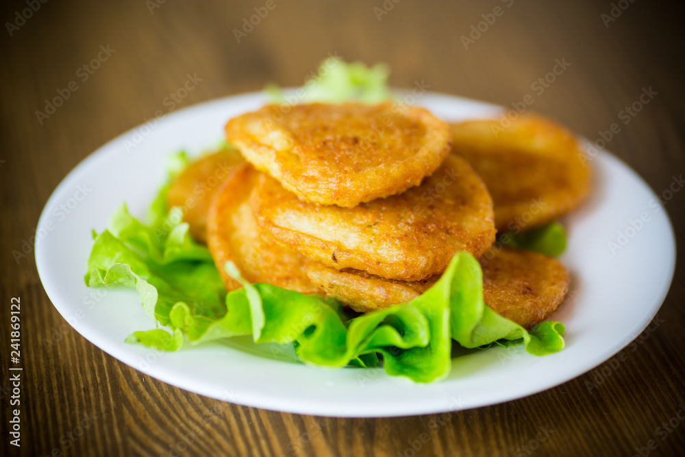 potato pancakes with lettuce leaves in a plate