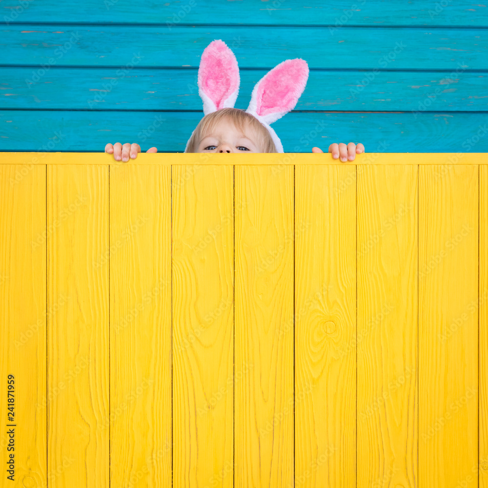 Funny kid wearing Easter bunny - obrazy, fototapety, plakaty 