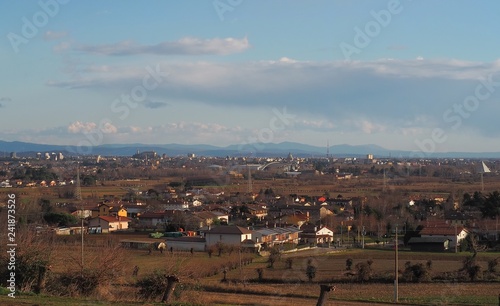 Cityscape of Udine, the ancient capital of Friuli Homeland, in the background, before sunset