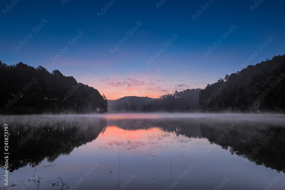 sunrise at Pang Oung, lake view morning beautiful scenic of pine forest with reflection on the surface of water with soft mist moving on the water, Pang Oung reservoir, Mae Hong Son, northern Thailand