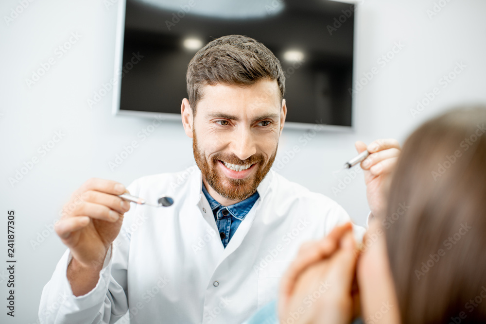 Enthusiastic male dentist with crazy facial expression during the procedure in the dental office