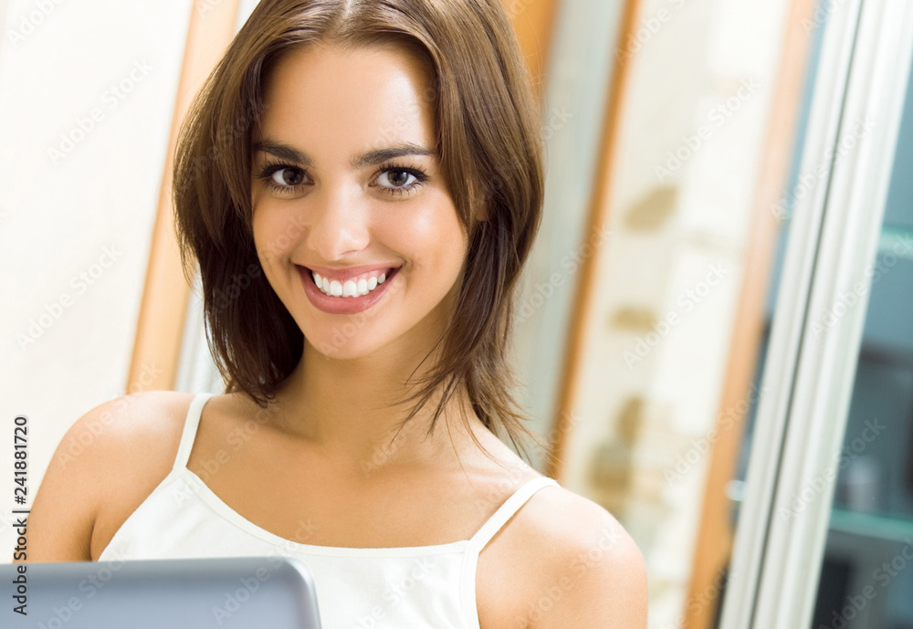 Cheerfull smiling woman working with laptop