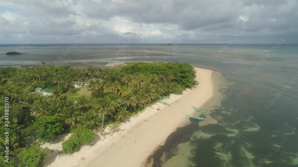 Aerial view tropical beach with turquoise water in blue lagoon, Punta verde, Philippines, Santa Ana. Ocean coastline, mountains covered rainforest. Tropical landscape in Asia. Aerial view tropical beach with turquoise water in blue lagoon, Punta verde, Philippines, Santa Ana. Ocean coastline, mountains covered rainforest. Tropical landscape in Asia.