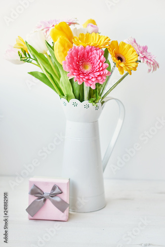 Fototapeta Naklejka Na Ścianę i Meble -  Spring and Easter holiday concept with copy space. Template Easter Greeting Card. Easter eggs and flowers on white background. aster decoration with eggs.