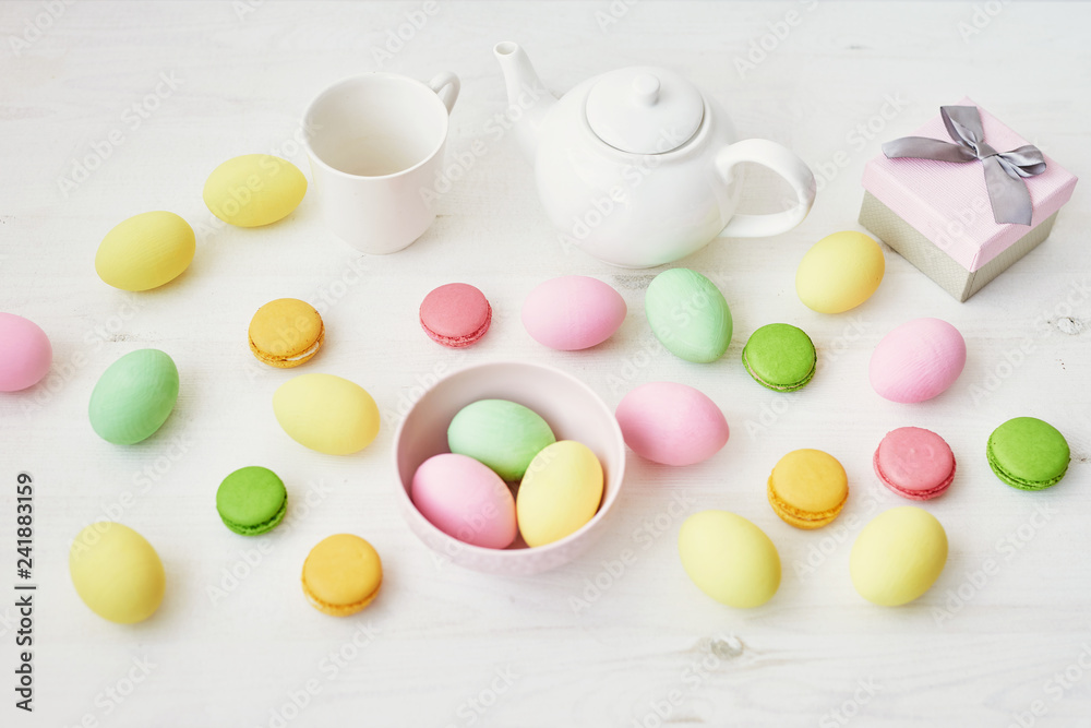 Spring and Easter holiday concept with copy space. Template Easter Greeting Card. Easter decoration with eggs and gift box. Macarons with Easter eggs background Spring and Easter holiday concept with copy space. Template Easter Greeting Card. Easter decoration with eggs and gift box. Macarons with Easter eggs background