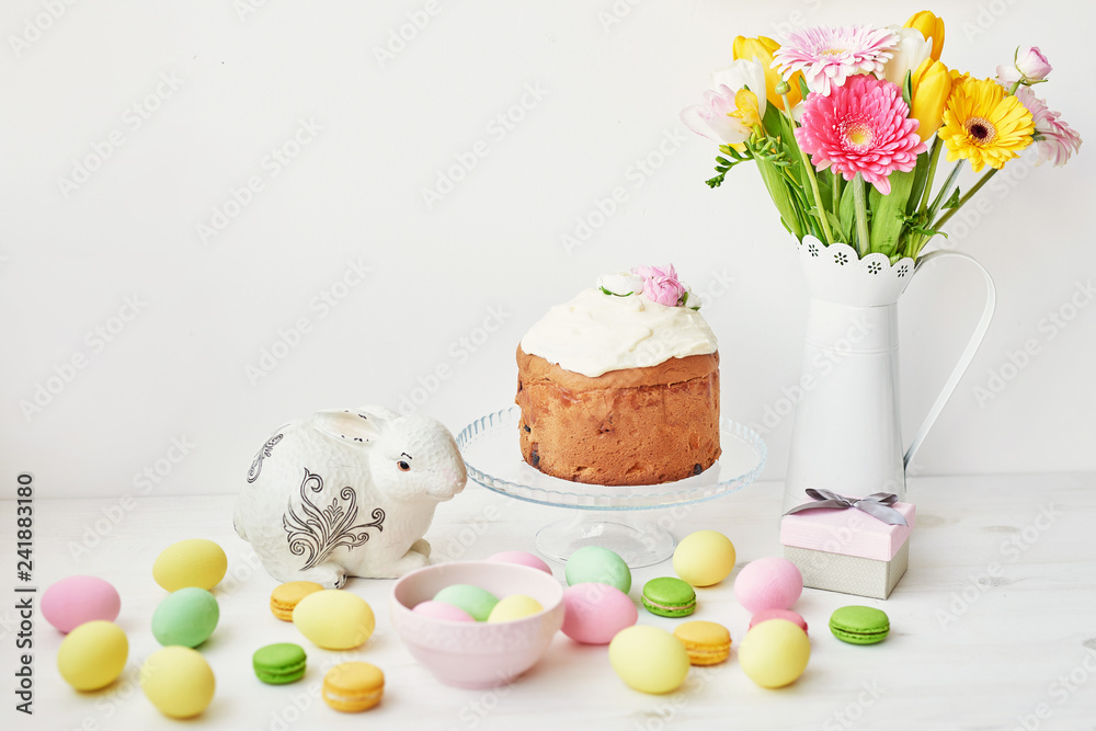Easter sweet bread, Easter cake and multi-colored eggs with tulips and a white rabbit. Holidays breakfast concept with copy space. Retro style in tones. Easter greeting card template