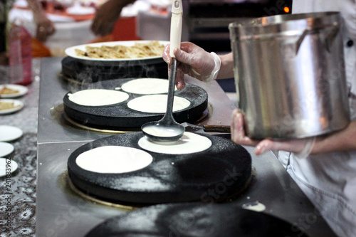 pancakes, baking pancakes, the chef prepares, Breakfast at the restaurant, The cook fries the pancake on the plate, the cooking process