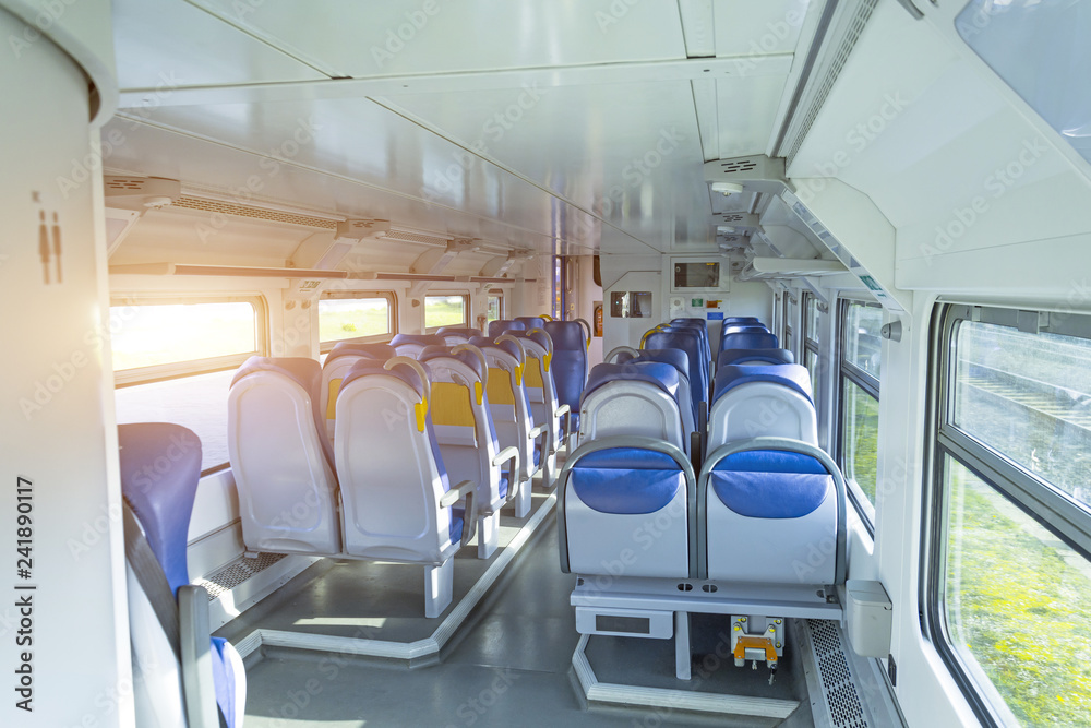 Fototapeta premium Salon inside of the speed commuter train with empty seats.
