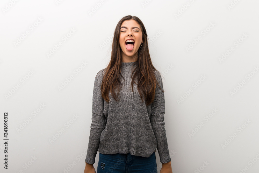 Teenager girl on isolated white backgorund showing tongue at the camera having funny look Teenager girl on isolated white backgorund showing tongue at the camera having funny look