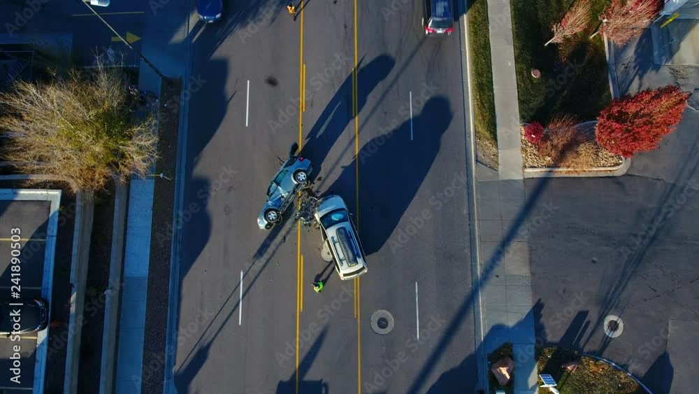 Aerial down to an rollover accident in the middle of the road. 