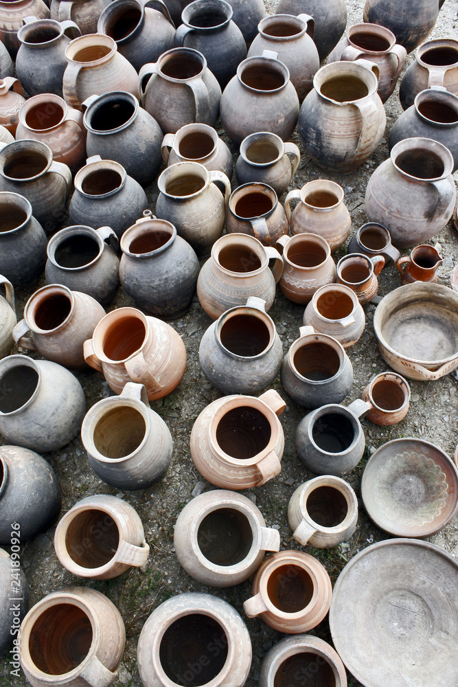 Used, plain pottery pots top view. Different sizes and shapes ceramics pots displayed for sale at a flea market. Used, plain pottery pots top view. Different sizes and shapes ceramics pots displayed for sale at a flea market.