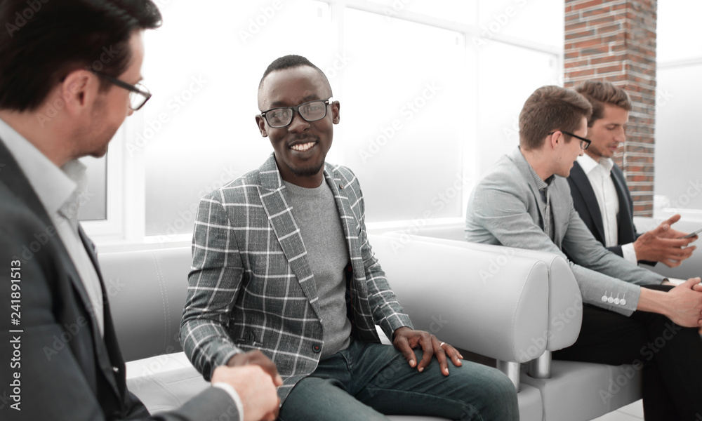 group of young employees are waiting for an interview in the office lobby group of young employees are waiting for an interview in the office lobby