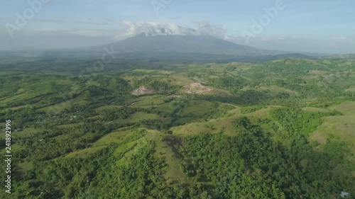 Aerial view mountain valley with hills covered forest, trees, mount Iriga. Luzon, Philippines. Slopes of mountains with evergreen vegetation. Mountainous tropical landscape. photo