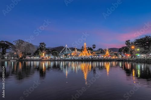 Lake view evening of Wat Chong Klang and Wat Chong Kham Chedi Myanmar style art with reflection on the surface of water and colorful twilight vivid sky background  Mae Hong Son  northern of Thailand.