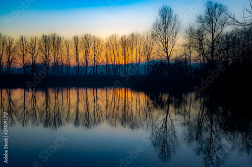 Piedmont, Italy, lakefront at sunset, in the park of the river po