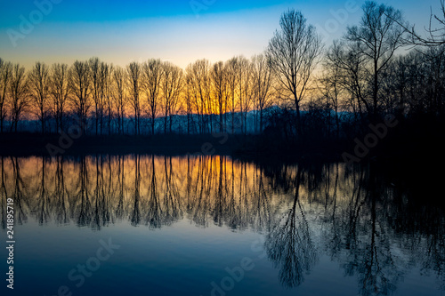 Piedmont, Italy, lakefront at sunset, in the park of the river po