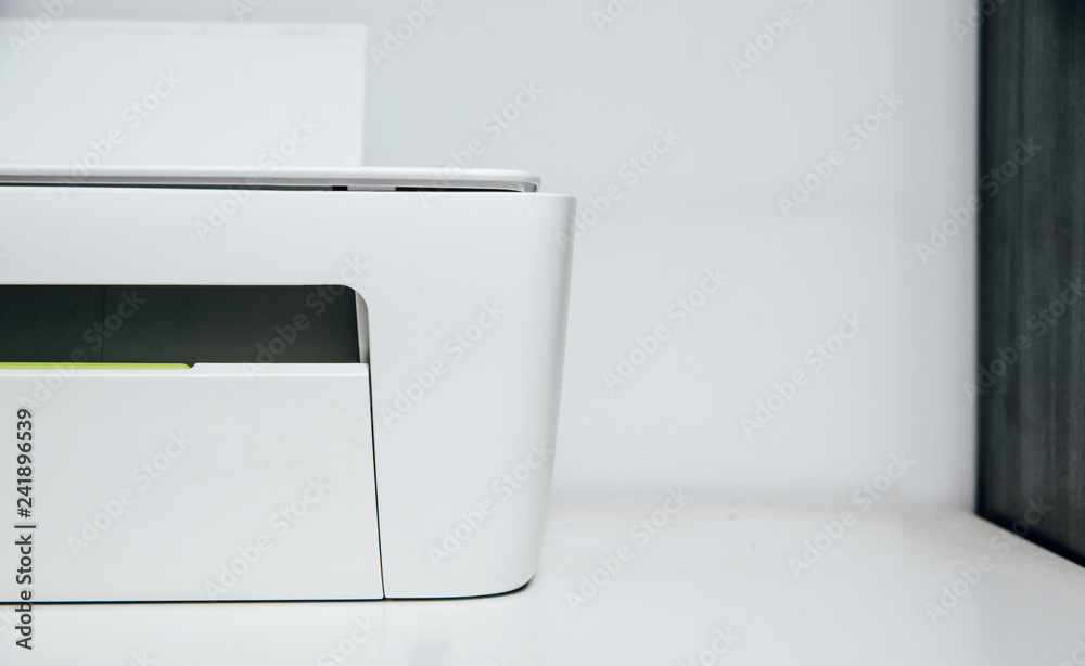 Half of White, bright printer on table. Isolated multifunction device. The concept of office equipment, the use of copying papers, scanning. Half of White, bright printer on table. Isolated multifunction device. The concept of office equipment, the use of copying papers, scanning.