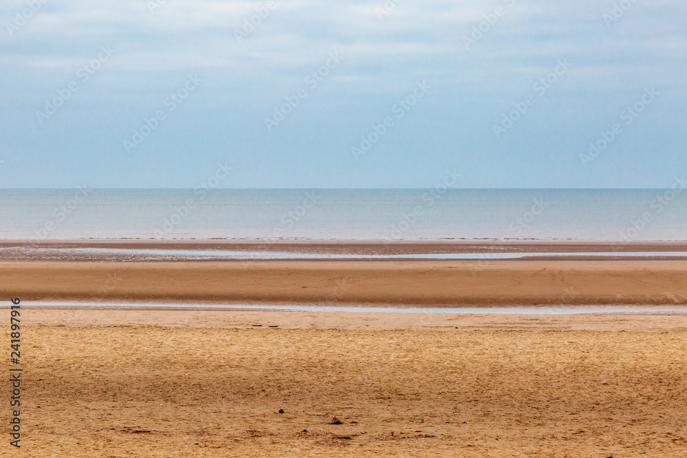 Looking out to sea over a sandy beach, at Formby, Merseyside