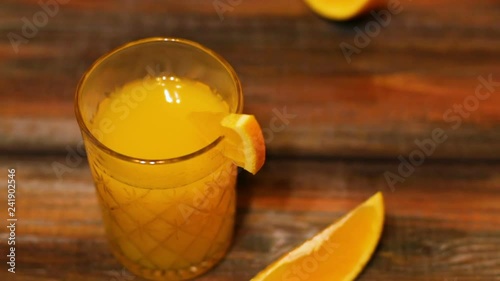 Orange juice is poured into glasses on a wooden table. Healthy food, diet. Breakfast concept