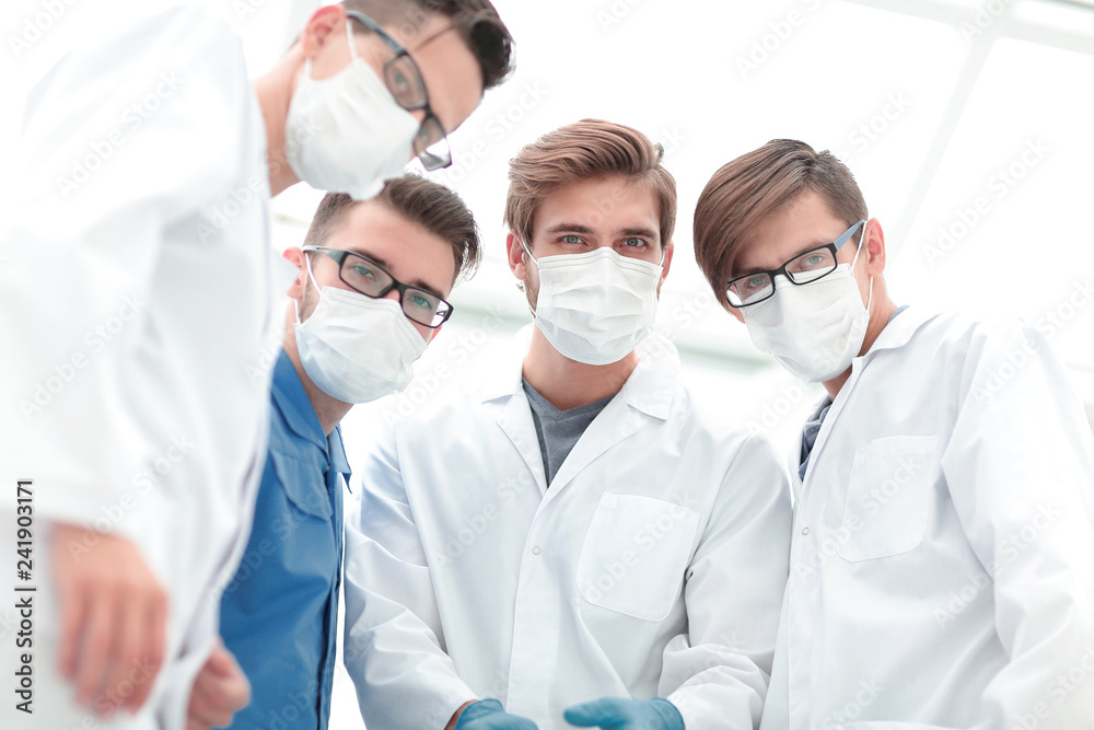 closeup. a team of doctors in protective masks. closeup. a team of doctors in protective masks.