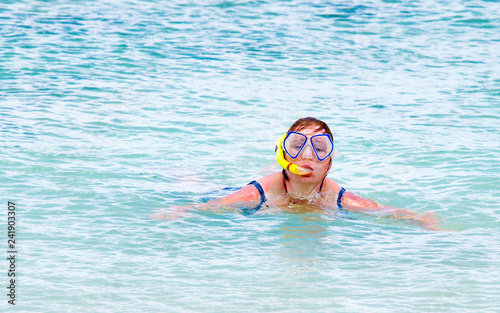 Overweight woman swimming and snorkeling during summer vacations.