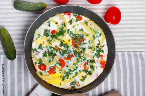 Traditional rustic omelette with bacon, pasta and greens . Copy space