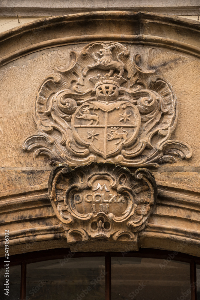 Old historical building with coats of arms made of stone