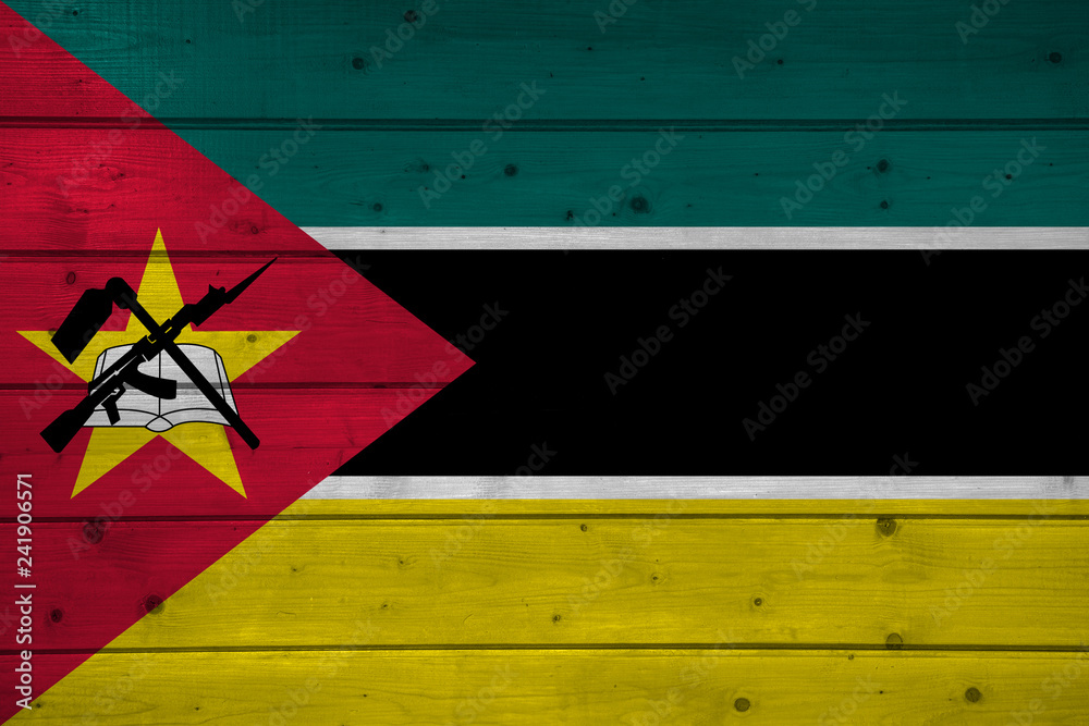 Naklejka premium Flag of Mozambique on wooden background, surface. Wooden wall, planks. National flag