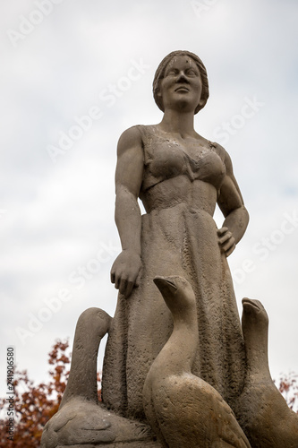 A fountain of stine in shape of a woman and geese photo