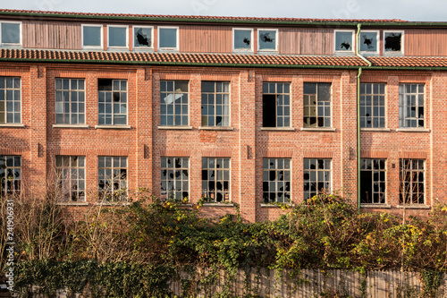 Old destroyed brick house ruin with broken windows