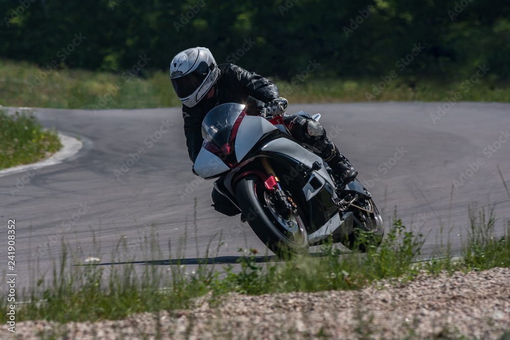The sports motorcycle at high speed overcomes a sharp corner