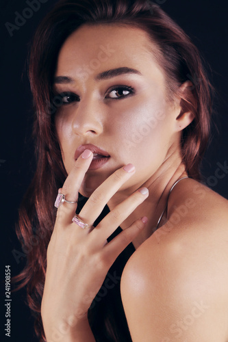 Beautiful Young Woman with jewelry on fingers, glamour Portrait